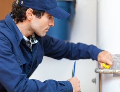 Technician fixing a water heater
